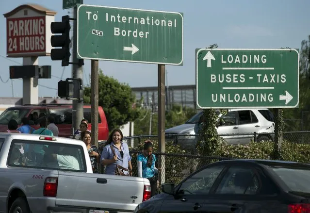 Pedestrians walk into the border town of San Ysidro after crossing into the United States from Mexico in the border town of San Ysidro, California September 2, 2015. Picture taken September 2, 2015. (Photo by Mike Blake/Reuters)