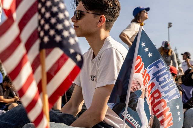 Ethan Jackline, sits next to a flag planted by a friend as they attend a “Fighting Oligarchy” rally with Sen. Bernie Sanders (I-VT) and Rep. Alexandria Ocasio-Cortez (D-NY) in Folsom, Calif., Tuesday, April 15, 2025. (Photo by Stephen Lam/San Francisco Chronicle via Getty Images)