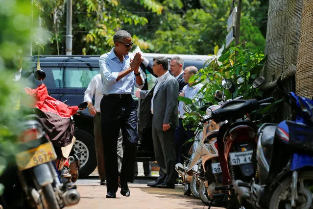 U.S. President Barack Obama greets local residents on a walk in Luang Prabang, Laos September 7, 2016. (Photo by Jonathan Ernst/Reuters)