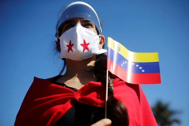A supporter of Venezuela's President Nicolas Maduro attends a ceremony to celebrate the Venezuela's Independence Day in front of Venezuelan embassy in Brasilia, Brazil, July 5, 2020. (Photo by Adriano Machado/Reuters)