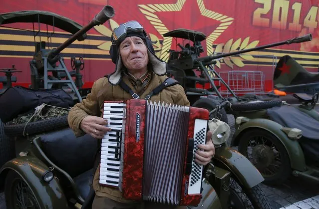 A man dressed in a historical uniform plays an accordion as he takes part in a rehearsal for a military parade at the Red Square in Moscow November 5, 2014. (Photo by Maxim Shemetov/Reuters)