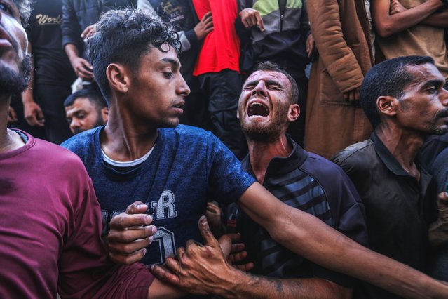 Palestinians react outside Nasser Hospital in Khan Yunis on June 17, 2025 as the wounded and the bodies of those killed in an Israeli strike near a humanitarian aid distribution centre are brought to the facility. (Photo by Abed Rahim Khatib/picture alliance via Getty Images)