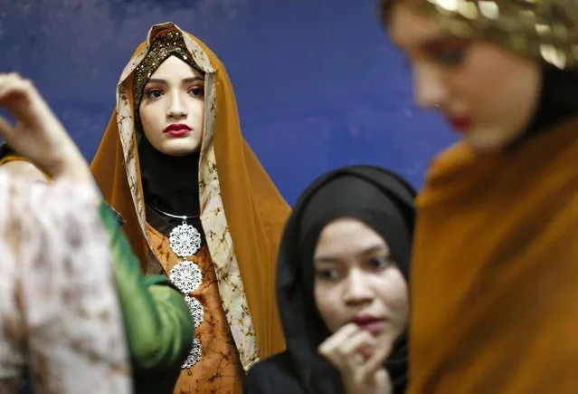 Models wear creations from the MSF collection backstage at the Islamic Fashion Festival in Kuala Lumpur November 18, 2014. (Photo by Olivia Harris/Reuters)