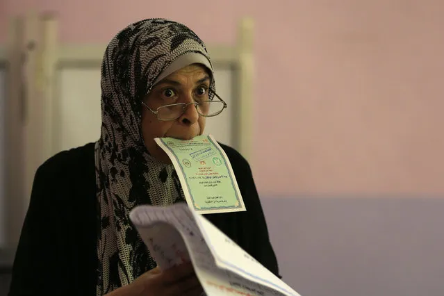 An Egyptian woman casts her vote in the Egyptian parliamentary elections at a polling station in Alexandria, Egypt, Sunday, October 18, 2015. (Photo by Hassan Ammar/AP Photo)