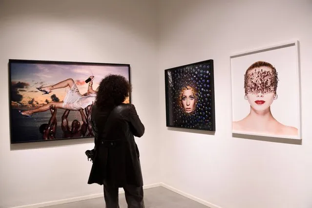 A woman attends the preview of the exhibition “Unconventional”, a selection of unseen colour photographs by Italian fashion photographer Gian Paolo Barbieri, in Milan, Italy, November 28, 2022. (Photo by Flavio Lo Scalzo/Reuters)