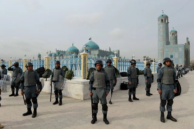 Afghan policemen stand guard at the shrine of Hazrat-i Ali ahead of “Nowruz”, the Persian New Year in Mazar-i-Sharif on March 20, 2013. (Photo by Shah Marai/AFP Photo)