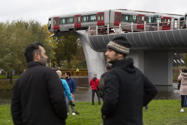 The whale's tail of a sculpture caught the front carriage of a metro train as it rammed through the end of an elevated section of rails with the driver escaping injuries in Spijkenisse, near Rotterdam, Netherlands, Monday, November 2, 2020. (Photo by Peter Dejong/AP Photo)