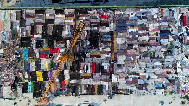 Aerial view of quilts covering the top of the building to protect concrete from frost at a construction site on February 6, 2018 in Jinan, Shandong Province of China. The top of the concrete-cast building is covered with over 200 quilts occupying 2,000 square metres to protect it from freezing cold weather conditions. (Photo by VCG/VCG via Getty Images)