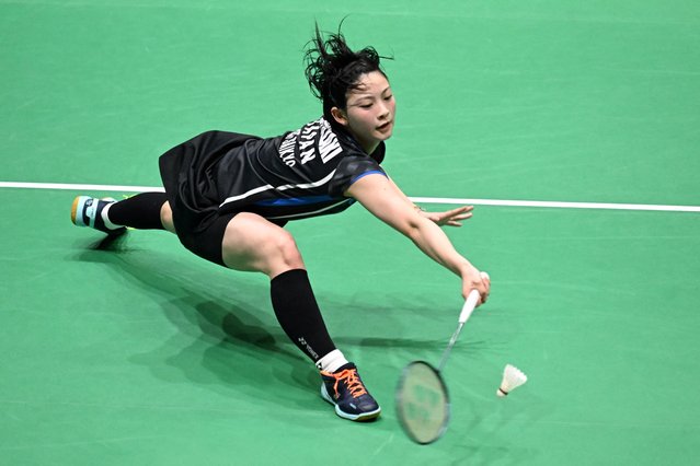 Tomoka Miyazaki of Japan hits a return against Lin Hsiang-Ti of Taiwan in their women's singles quarter-final match during the Hong Kong Open badminton tournament in Hong Kong on September 12, 2025. (Photo by Peter Parks/AFP Photo)