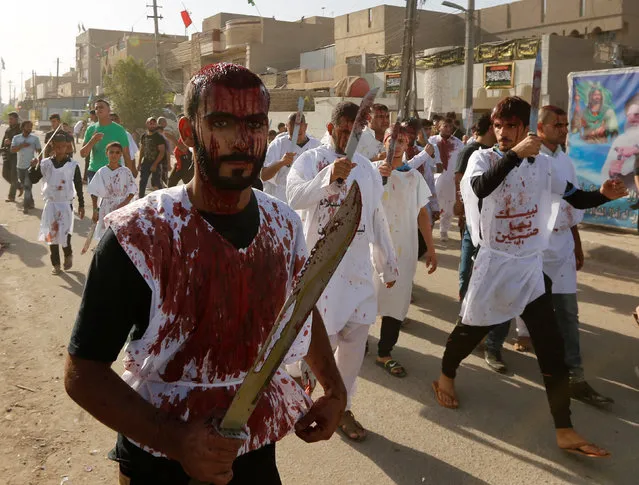 Iraq Shi'ite Muslim men bleed as they gash their foreheads with swords and beat themselves while commemorating Ashura in Baghdad, Iraq ,October 12, 2016. (Photo by Ahmed Saad/Reuters)