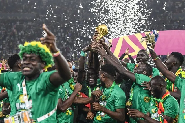 Senegal's players celebrate with the trophy after winning the Africa Cup of Nations (CAN) 2021 final football match between Senegal and Egypt at Stade d'Olembe in Yaounde on February 6, 2022. (Photo by Charly Triballeau/AFP Photo)