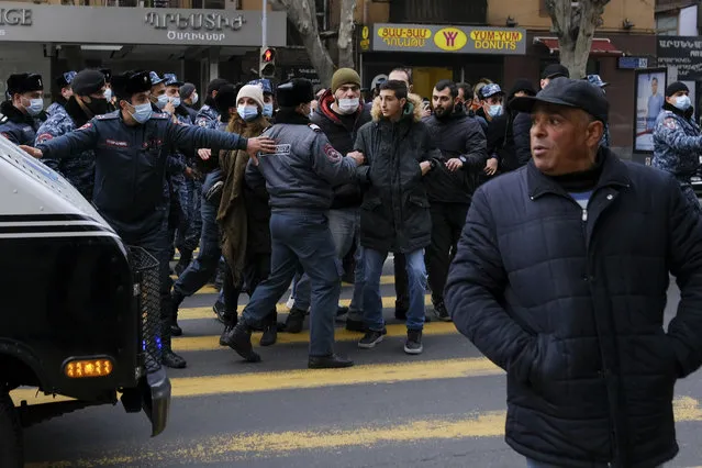Police try to block demonstrators during a rally demanding the resignation of the country's prime minister over his handling of the conflict with Azerbaijan over Nagorno-Karabakh in Yerevan, Armenia, Tuesday, December 8, 2020.Armenian opposition politicians and their supporters have been calling for Prime Minister Nikol Pashinyan to step down ever since he signed a peace deal that halted 44 days of deadly fighting over the separatist region, but called for territorial concessions to Azerbaijan. (Photo by Aram Kirakosyan/PAN Photo via AP Photo)