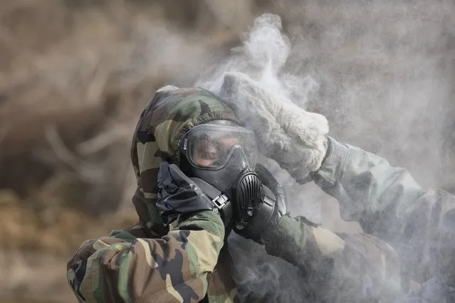 U.S. soldiers try to remove the mock chemical pollutants during a joint military drill between South Korea and the United States in Paju, South Korea, Thursday, March 16, 2023. North Korea test-launched an intercontinental ballistic missile Thursday just hours before the leaders of South Korea and Japan were to meet at a Tokyo summit expected to be overshadowed by North Korean nuclear threats. The North's first ICBM test in a month and third weapons tests this week also comes as South Korean and U.S. troops continue joint military exercises that Pyongyang considers a rehearsal to invade. (Photo by Lee Jin-man/AP Photo)