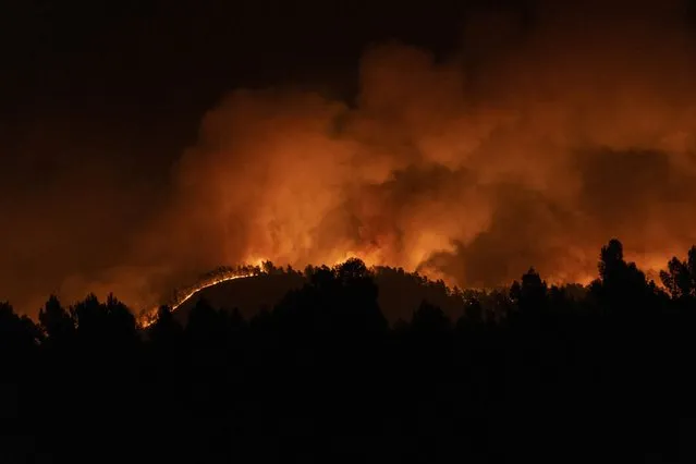 A forest fire burns in the hills near Villanueva de Viver, Spain, in the early hours of Friday March 24, 2023. Hundreds of people were evacuated as a major forest fire raged in Spain's eastern Castellon region on Friday, marking the early start to the nation's fire season amid bone dry conditions. (Photo by Lorena Sopena/Europa Press via AP Photo)