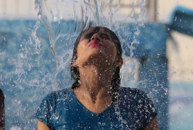 An Indian girl enjoys a swimming pool at Kanha Fun City Water Park in Bhopal on April 27, 2018. Bhopal experienced highest temperature of season reaching 42.1 degree Celsius according to Regional Meteorological Center. Rajgarh and Damoh district of Madhya Pradesh recorded a maximum temperature of 44 Degree Celsius. (Photo by AFP Photo/Stringer)