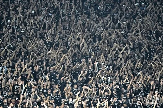 Fans of Brazil's Corinthians cheer during a Copa Libertadores group E soccer match against Argentina's Argentinos Juniors at the Corinthians Arena in Sao Paulo, Brazil, Wednesday, April 19, 2021. (Photo by Andre Penner/AP Photo)