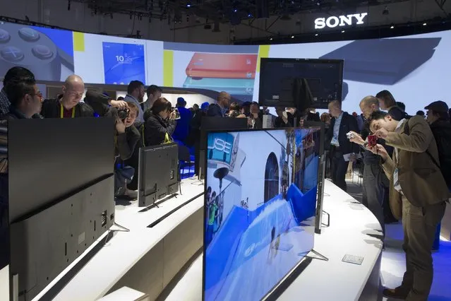 Journalists take photos of Sony 4K televisions at a Sony news conference during the 2015 International Consumer Electronics Show (CES) in Las Vegas, Nevada January 5, 2015. (Photo by Steve Marcus/Reuters)