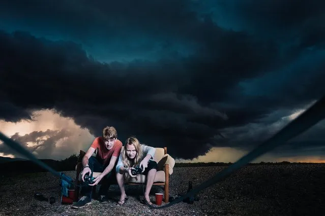 Models pose in front of a storm in Wheatland, Wyoming. (Photo by Benjamin Von Wongs/Caters News)