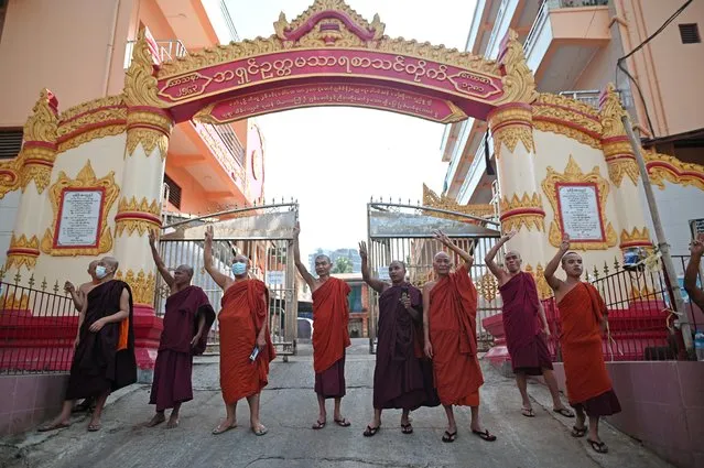 Buddhist monks show the three-finger salute as they join a rally in a protest against the military coup and to demand the release of elected leader Aung San Suu Kyi, in Yangon, Myanmar, February 8, 2021. (Photo by Reuters/Stringer)