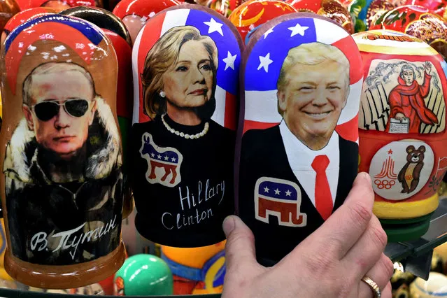 Traditional Russian wooden nesting dolls, Matryoshka dolls, depicting Russia's President Vladimir Putin, US Democratic presidential nominee Hillary Clinton and US Republican presidential nominee Donald Trump are seen on sale at a gift shop in central Moscow on November 8, 2016. A nervous world turned its gaze to America's 200 million-strong electorate November 8, 2016 as it chooses whether to send the first female president or a populist property tycoon to the White House. (Photo by Kirill Kudryavtsev/AFP Photo)
