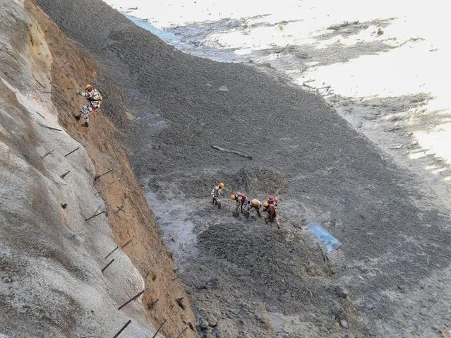 This photograph provided by Indo Tibetan Border Police (ITBP) shows ITBP personnel begin rescue work after a portion of Nanda Devi glacier broke off in Tapovan area of the northern state of Uttarakhand sending a massive flood of water, mud and debris into areas below, India, Sunday, February 7, 2021. (Photo by Indo Tibetan Border Police via AP Photo)