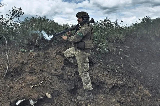 A Ukrainian soldier fires an RPG toward Russian positions at the frontline near Bakhmut in the Donetsk region, Ukraine, Monday, May 22, 2023. (Photo by Libkos/AP Photo)