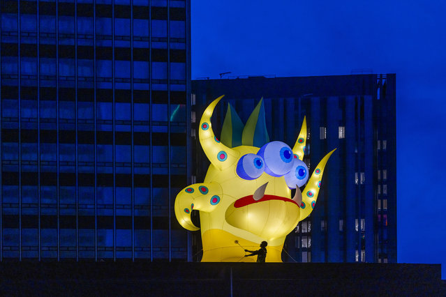 Rigger Ian “cookie” Brooks installs the Wailor Swift inflatable monster designed by Filthy Luker and Pedro Estrellas and commissioned by Manchester City Centre Business Improvement District (BID) at New Century at NOMA on Wednesday, October 23, 2024 as part of Manchester's annual Halloween in the City celebrations this weekend. (Photo by PA Wire via Reuters)
