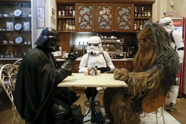 Darth Mykolaiovych Vader (L), who is dressed as the Star Wars character Darth Vader, poses for a picture as he speaks to people dressed as Star Wars characters Chewbacca (R) and a Stormtrooper in a cafe in Odessa, Ukraine, December 3, 2015. (Photo by Valentyn Ogirenko/Reuters)