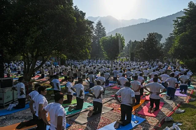 Practitioners take part in a yoga session on the International Day of Yoga, in Srinagar on June 21, 2023. (Photo by Tauseef Mustafa/AFP Photo)
