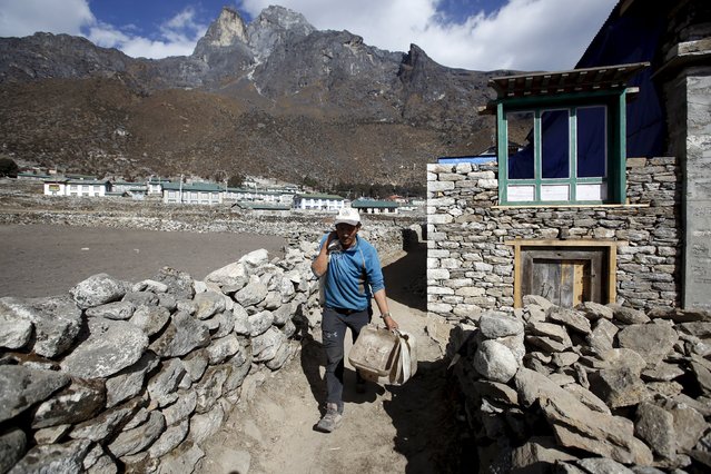 Phurbha Tashi Sherpa, 21-time Everest summiteer, carries a sack of potatoes as he heads to feed his yaks at Khumjung, a typical Sherpa village in Solukhumbu district also known as the Everest region, in this picture taken November 30, 2015. (Photo by Navesh Chitrakar/Reuters)