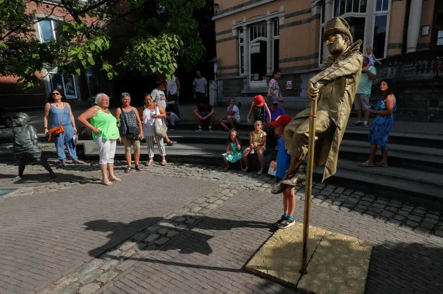 An artist called “Levitating Statue” takes part in the festival “Statues en Marche” in Marche-en-Famenne, Belgium, July 22, 2018. (Photo by Yves Herman/Reuters)
