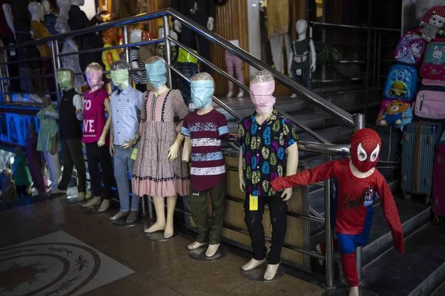 Mannequins with covered faces are displayed in a clothing store downtown in Kabul, Afghanistan, Friday, May 26, 2023. The Government of the Taliban prohibited the faces of the mannequins that are in commercial stores from being seen. (Photo by Rodrigo Abd/AP Photo)