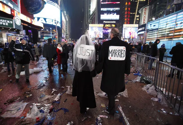 Melessa and Rick Clark leave the New Year celebration after exchanging vows in Times Square, New York January 1, 2010. (Photo by Jessica Rinaldi/Reuters)