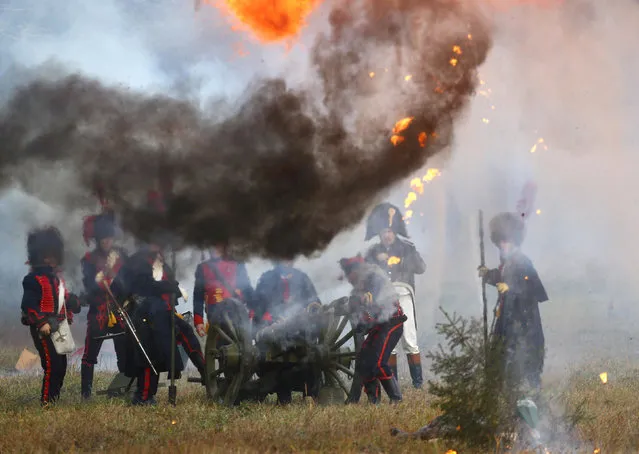 People dressed in the historic uniforms of the French army take part in a re-enactment of the 1812 Battle of Berezina, to mark the 204th anniversary of the battle, near the village of Bryli, Belarus, November 27, 2016. (Photo by Vasily Fedosenko/Reuters)