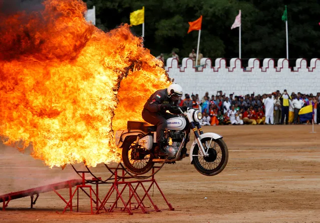 An Indian army soldier performs a stunt on his motorcycle during India's Independence Day celebrations in Bengaluru, India, August 15, 2018. (Photo by Abhishek N. Chinnappa/Reuters)