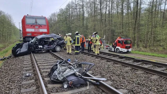 Emergency services at the scene of an incident, in Neustadt am Rubenberge, Germany, Sunday, April 23, 2023. Police say a train has hit a car at a crossing in northern Germany, killing all three people in the car. The regional train hit the car at full speed near Neustadt am Ruebenberge, outside the city of Hannover on Sunday morning. (Photo by TNN/dpa via AP Photo)