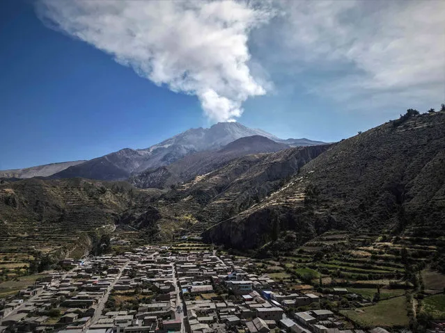 View of the Ubinas volcano from the town of Ubinas, in Moquegua, Peru, on 05 July 2023. The Council of Ministers of Peru approved on 05 July the declaration of a 60 day state of emergency for the districts near the Ubinas volcano (south), which is since 04 July in eruptive stage and has expelled columns of smoke and ash over 5 kilometers high. (Photo by EPA/EFE/Stringer)
