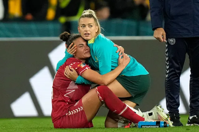 Denmark's Katrine Veje, left, is comforted by Australia's Charlotte Grant, right, after the Women's World Cup round of 16 soccer match between Australia and Denmark at Stadium Australia in Sydney, Australia, Monday, August 7, 2023. (Photo by Rick Rycroft/AP Photo)