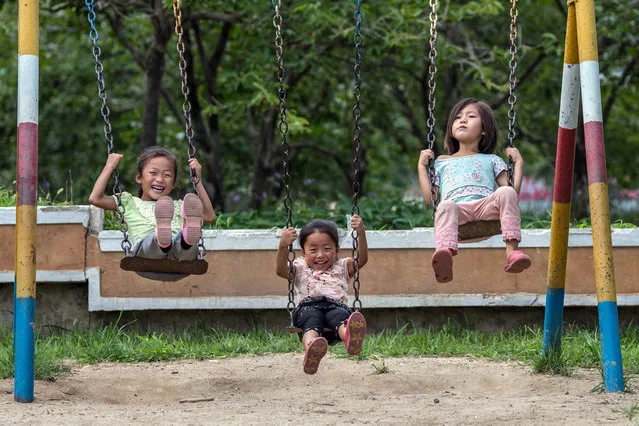 Children play on swings at a nursery for workers at Chonsam Cooperative Farm on August 22, 2018 in Wonsan, North Korea. (Photo by Carl Court/Getty Images)