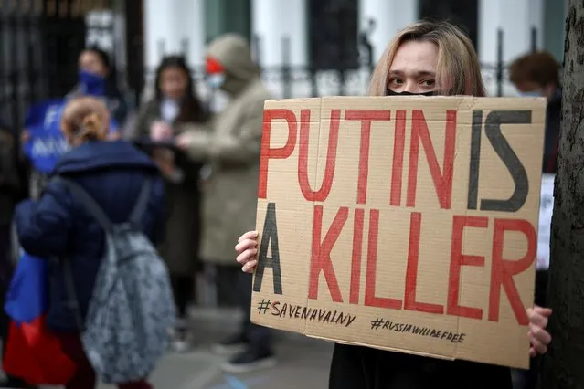 A woman holds a sign as she takes part in a demonstration in support of jailed Russian opposition politician Alexei Navalny outside the Russian Embassy in London, Britain, April 21, 2021. (Photo by Henry Nicholls/Reuters)
