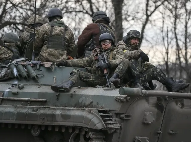 Ukrainian servicemen ride on a military vehicle near Artemivsk February 19, 2015. (Photo by Gleb Garanich/Reuters)