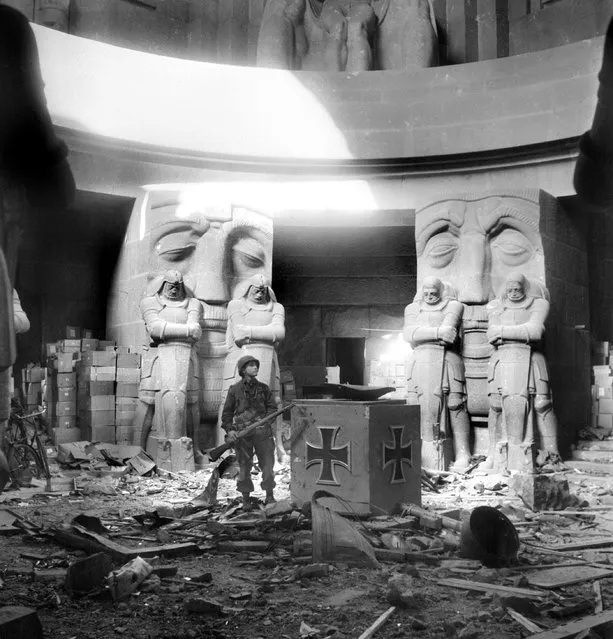 A US soldier stands in the middle of rubble in the Monument of the Battle of the Nations in Leipzig after they attacked the city 18 April 1945. (Photo by Eric Schwab/AFP Photo)