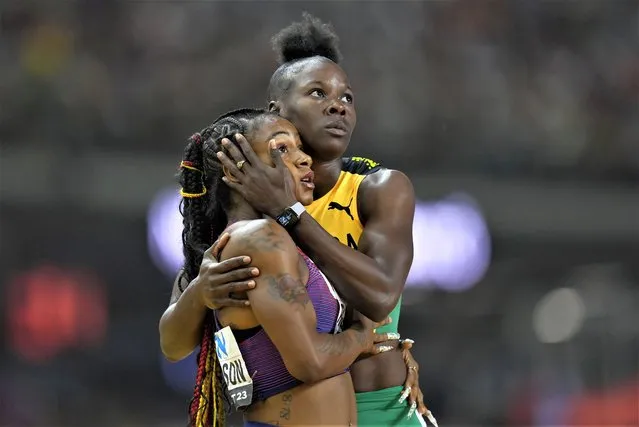 Shericka Jackson, of Jamaica, right, embraces Sha'Carri Richardson, of the United States, after finishing a Women's 200-meters semifinal during the World Athletics Championships in Budapest, Hungary, Thursday, August 24, 2023. (Photo by Petr David Josek/AP Photo)