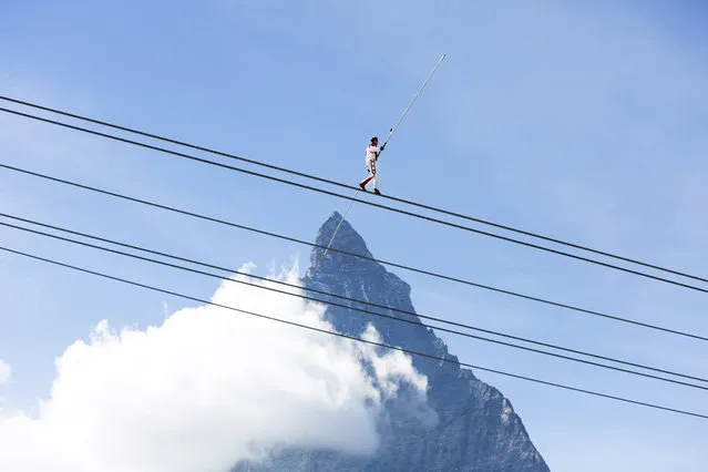 Freddy Nock, tightrope walker, walks on a rope in front of Matterhorn mountain during the inauguration ceremony of the new 3S ropeway in Zermatt, Valais, Switzerland, 29 September 2018. After three summer seasons of construction work with 38 involved companies and an invested sum of 52 million Swiss Francs the highest 3S ropeway is opening today in Zermatt. Therewith 2000 people can be transported all year around onto the Matterhorn glacier paradise, the highest mountain station in Europe. (Photo by Dominic Steinmann/EPA/EFE)