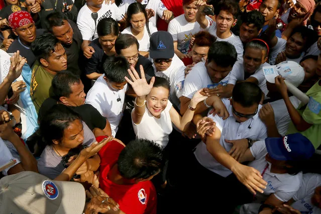 Sen. Grace Poe, a presidential hopeful, waves as she is mobbed by supporters as she arrives at the Philippine Supreme Court for the oral arguments following a petition that was filed questioning her citizenship in Manila, Philippines, Tuesday, January 19, 2016. The Philippines will hold presidential elections in May. (Photo by Bullit Marquez/AP Photo)