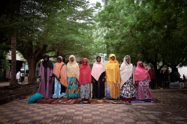 A group of women is seen praying in the courtyard of the Roi Faycal Bin Abdoulaziz Mosque during Eid al-Fitr, the holiday that marks the end of the Holy Month of Ramadan, in Bamako on May 12, 2021. (Photo by Michele Cattani/AFP Photo)