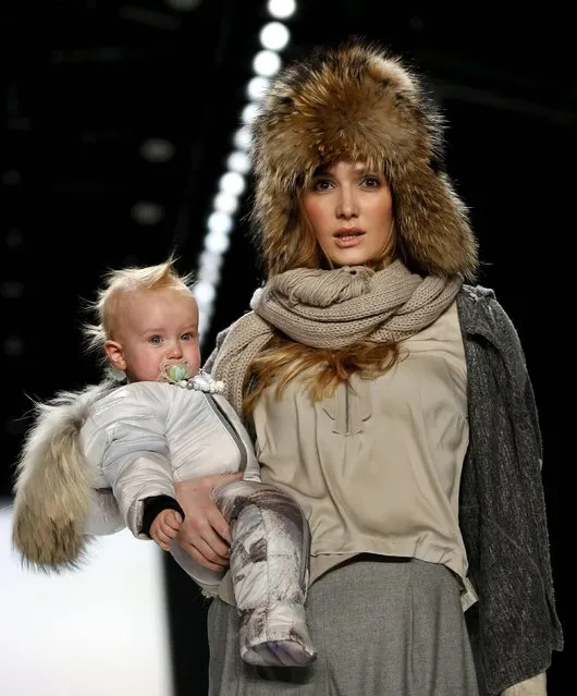 A model with a baby presents a creation by Sportalm at the Berlin Fashion Week Autumn/Winter 2016 in Berlin, Germany, January 19, 2016. (Photo by Fabrizio Bensch/Reuters)