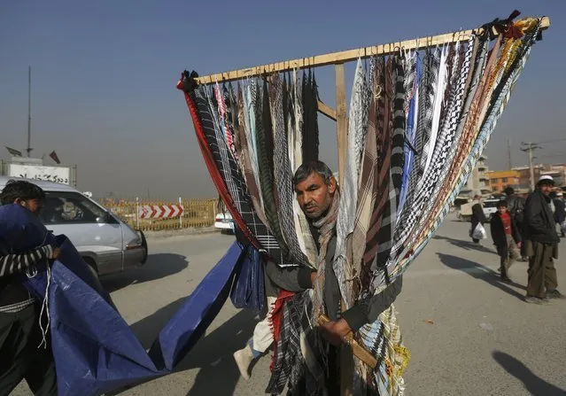 A man sells scarves as he waits for customers in Kabul, Afghanistan, November 29, 2015. (Photo by Omar Sobhani/Reuters)