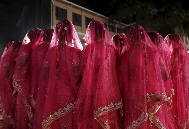 Muslim brides arrive to attend a mass marriage ceremony in Mumbai, India, January 27, 2016. (Photo by Danish Siddiqui/Reuters)