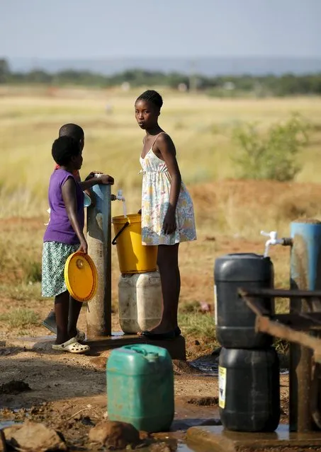 Villagers collect water from a communal tap in Rapotokwane village, Limpopo, March 21, 2015. (Photo by Siphiwe Sibeko/Reuters)